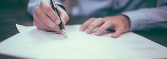 Professional reviewing compliance documents at a desk